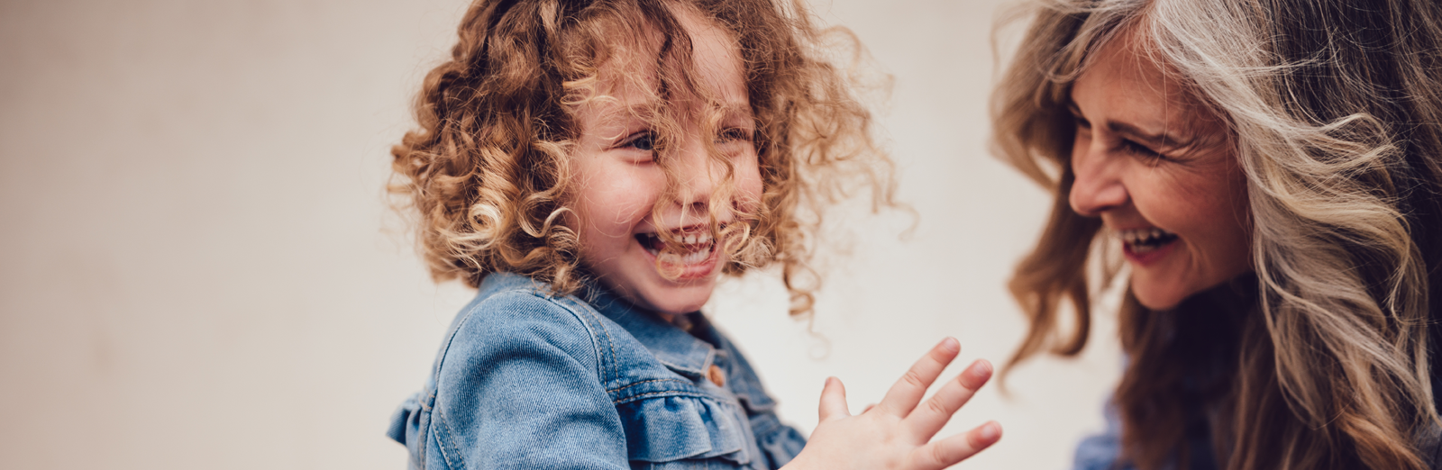 grandmother-grand-daughter-smiling-1600x522.png