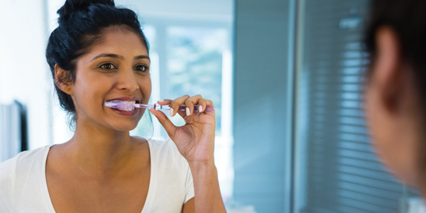 woman-brushing-teeth-600x300.jpg