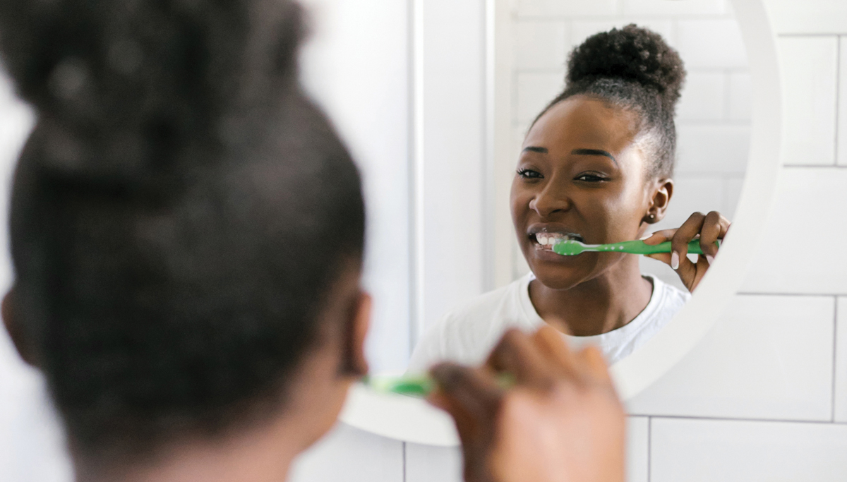 girl-brushing-teeth-in-mirror-1200x683.jpg