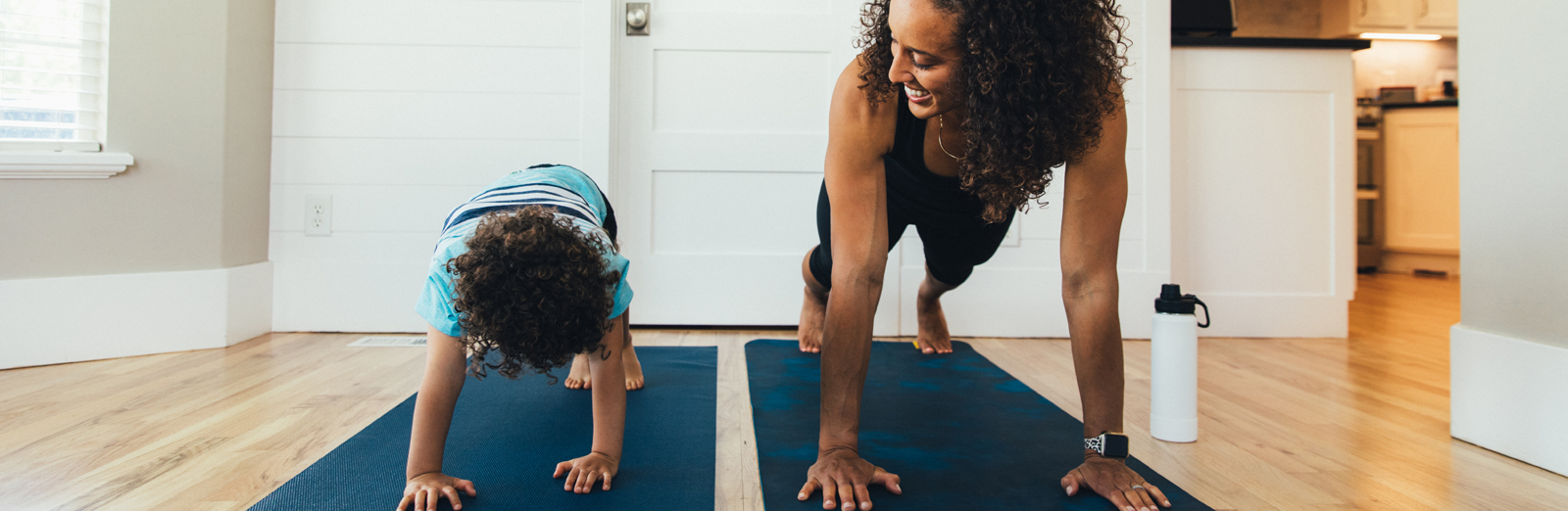 woman-exercising-with-child-1600x522.png