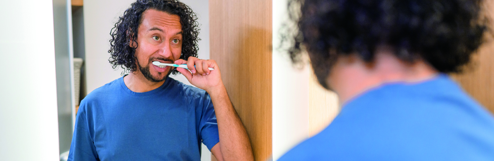 man-brushing-teeth-in-mirror-1600x522.jpg