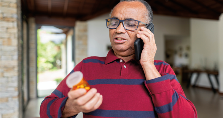 man-on-phone-looking-at-medication-752x400.png