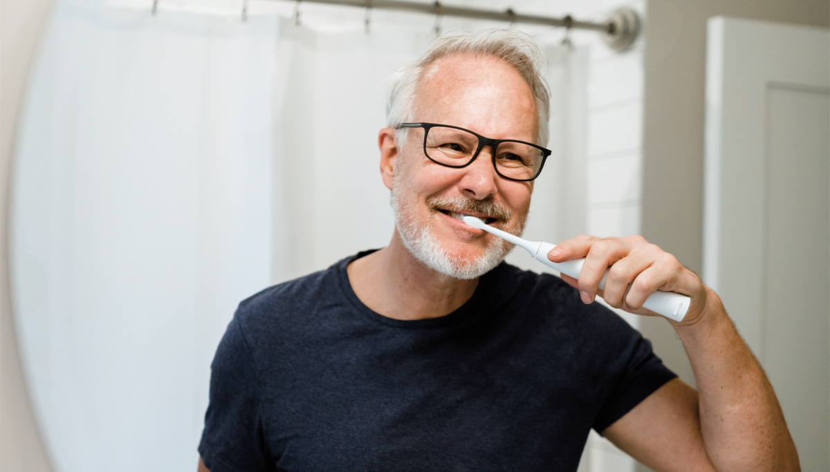 older-man-brushing-teeth-in-mirror-1200x683.jpg