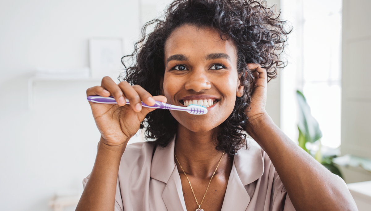 woman-smiling-brushing-teeth-1200x683.png