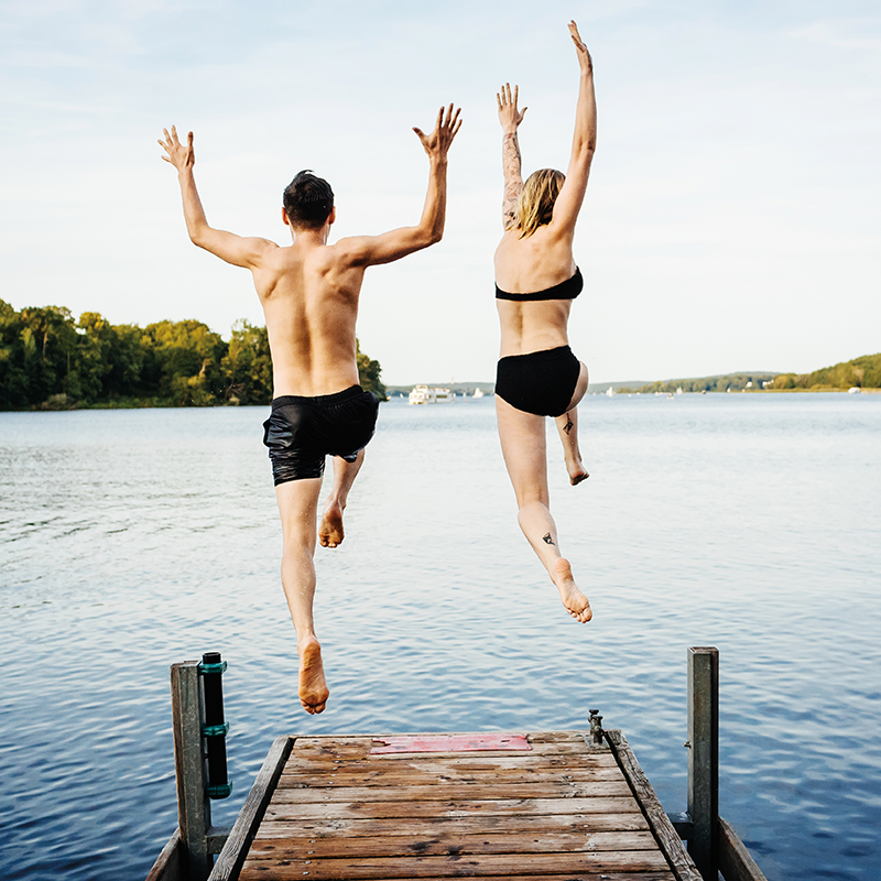 couple-jumping-off-dock-800x800.png