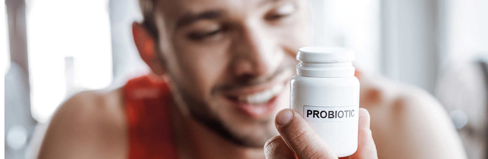 man-looking-at-probiotics-1600x522.png