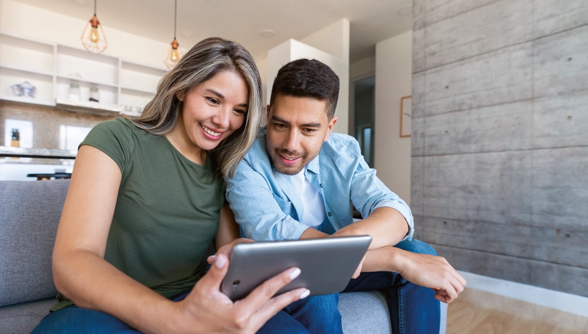 couple-looking-at-tablet-1200x683.webp