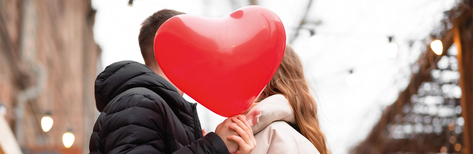 couple-with-heart-shaped-balloon-1600x522.webp