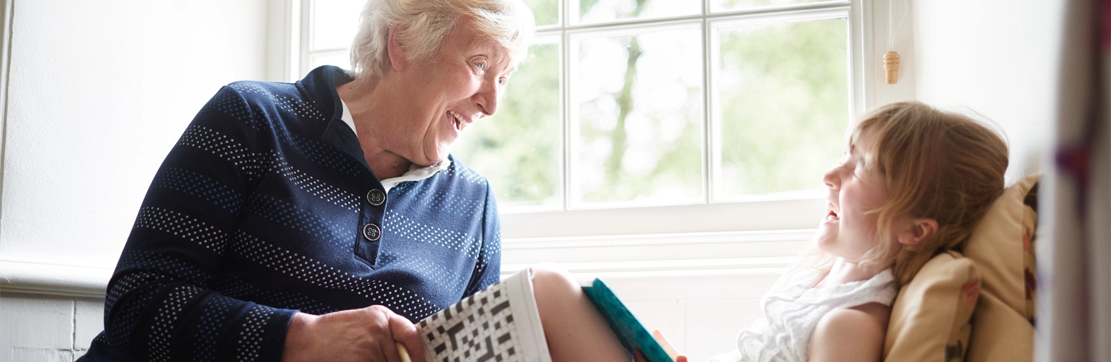 older-person-laughing-with-young-girl-1600x5221.webp