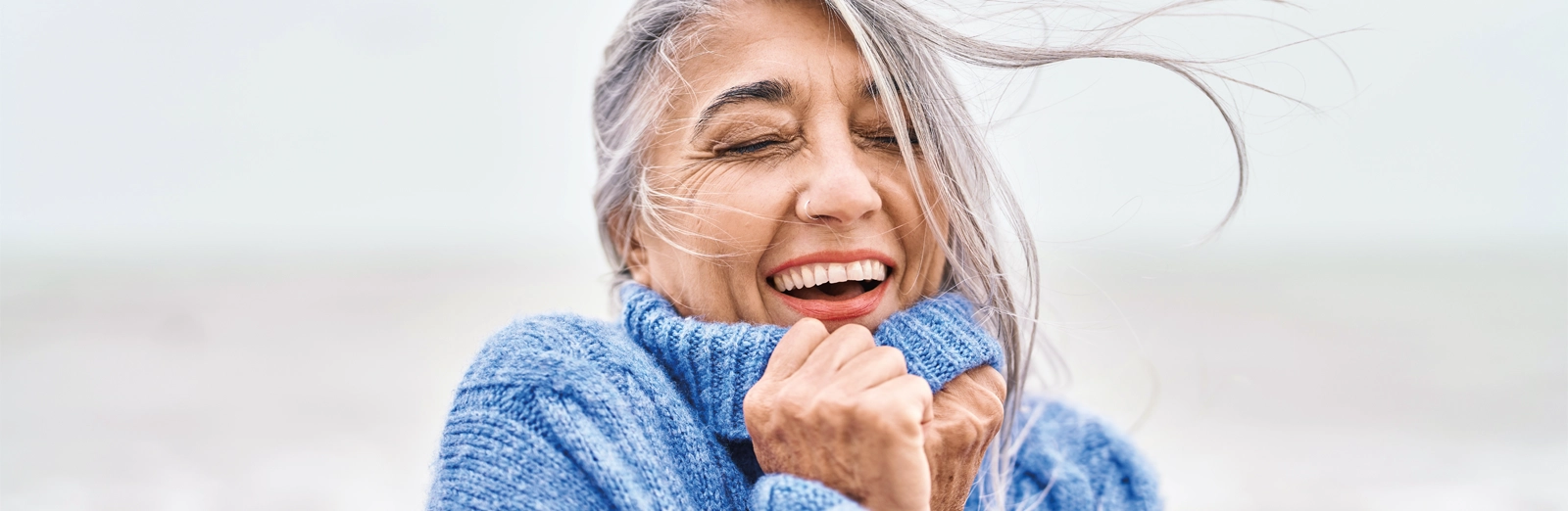 woman-smiling-outdoors-1600x522.webp