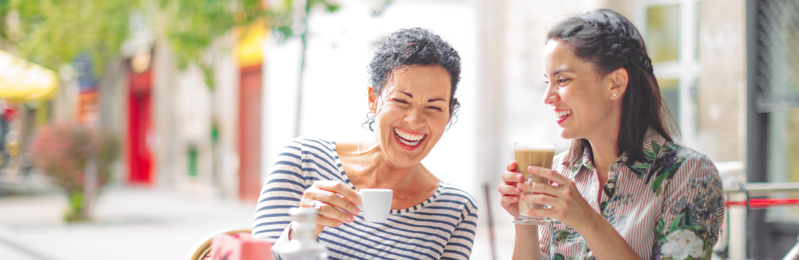 women-laughing-together-outside-1600x522.png