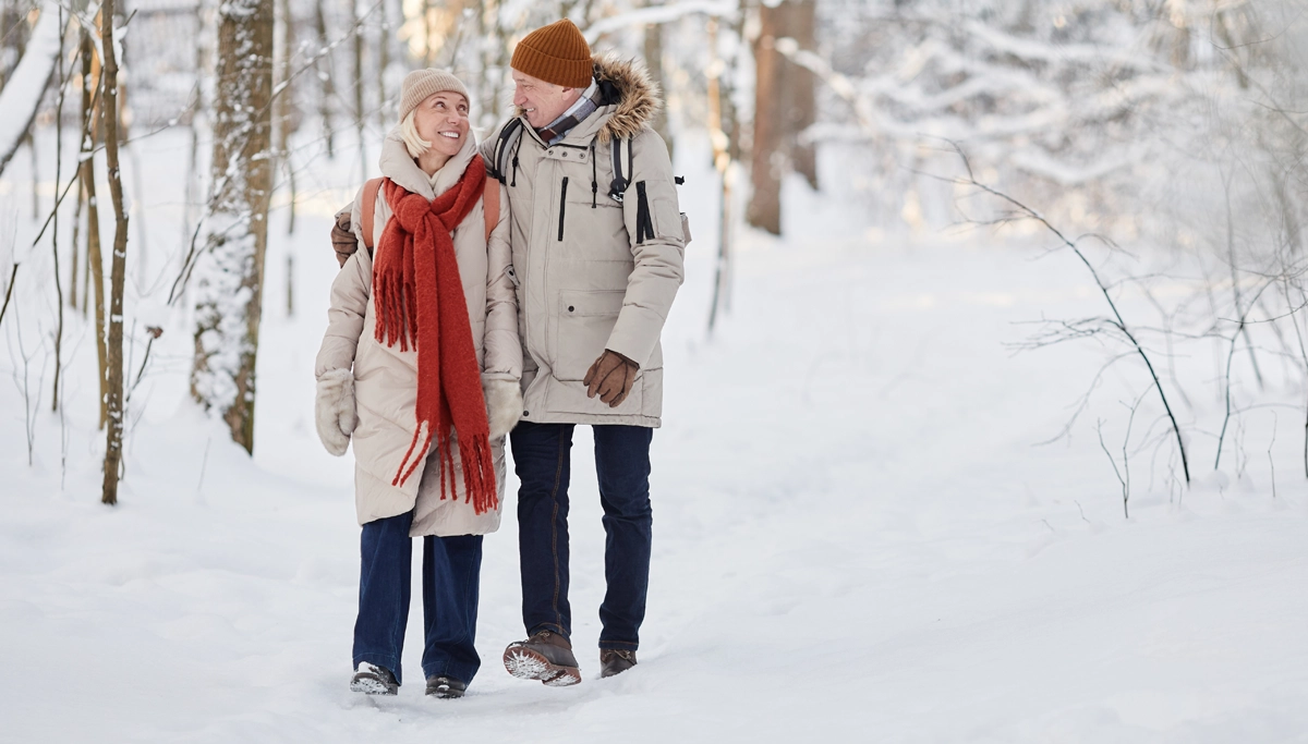 couple-walking-on-snowy-path-1200x683.webp