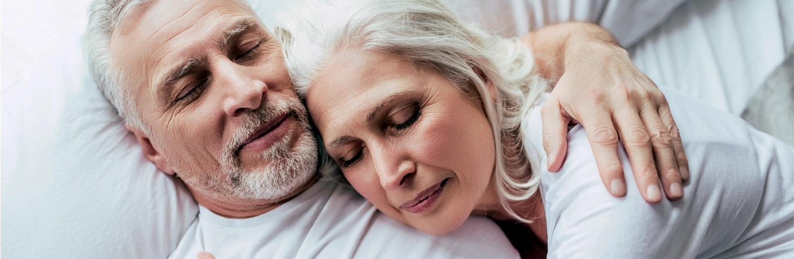 older-couple-sleeping-1600x522.webp
