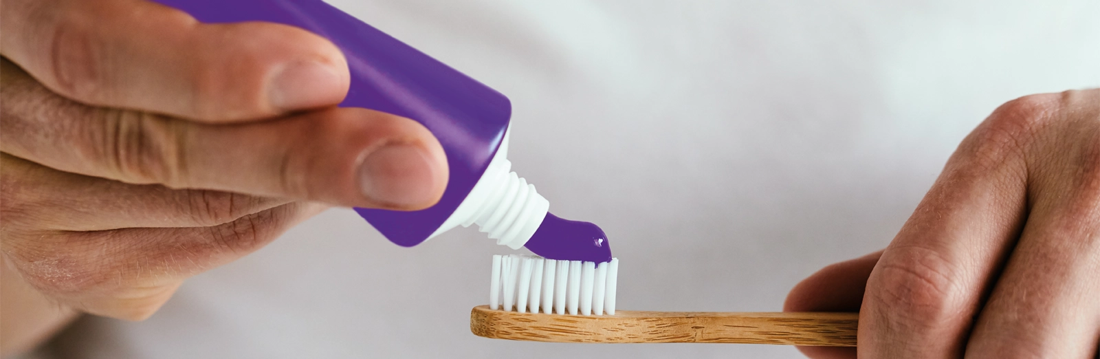 purple-toothpaste-on-a-toothbrush-1600x522.webp