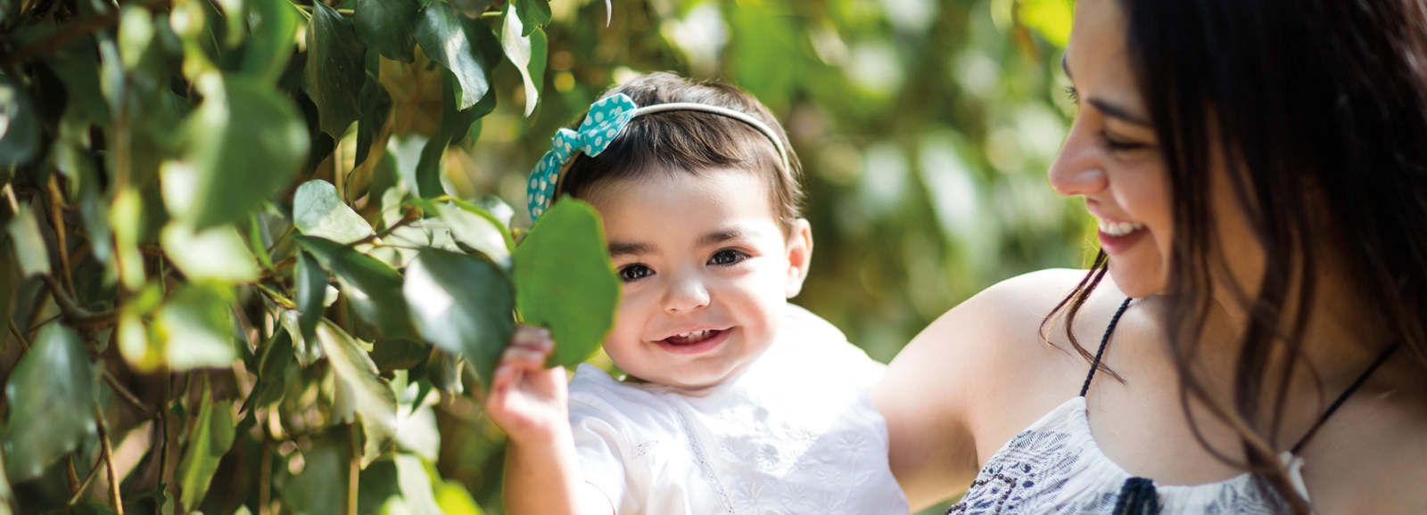 woman-and-baby-smiling-outside-1600x578.webp