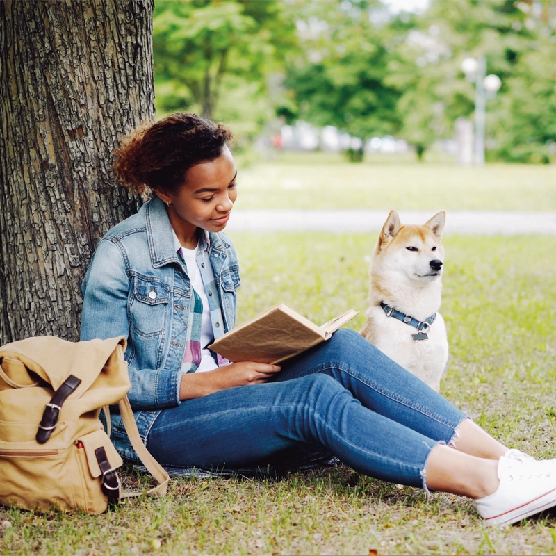 woman-reading-outside-with-dog-800x800.webp
