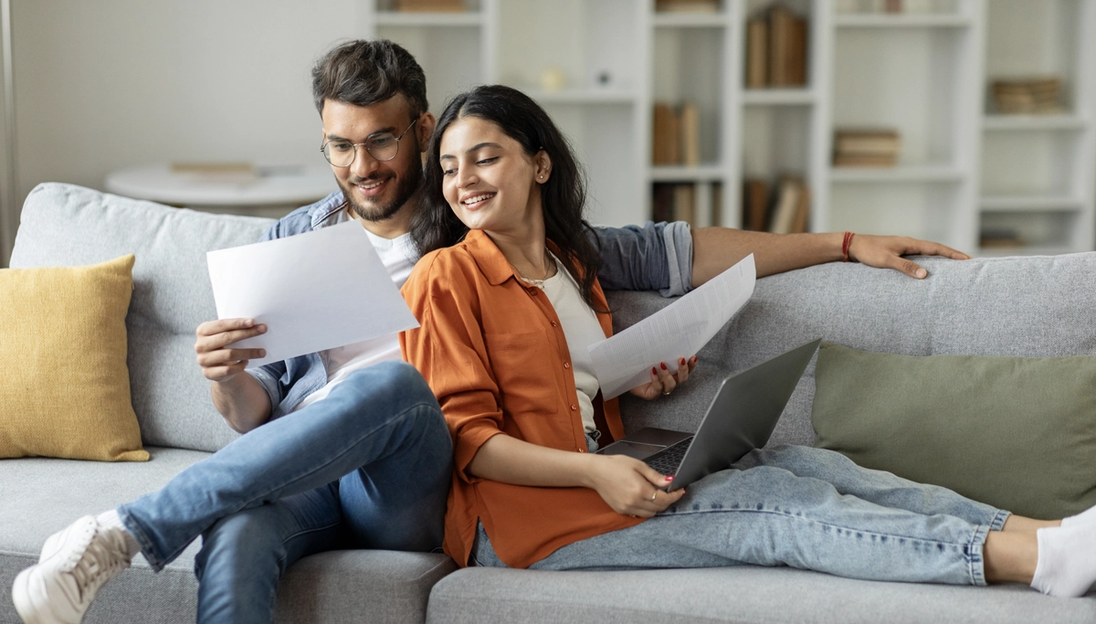 couple-smiling-reading-papers-1200x683.webp