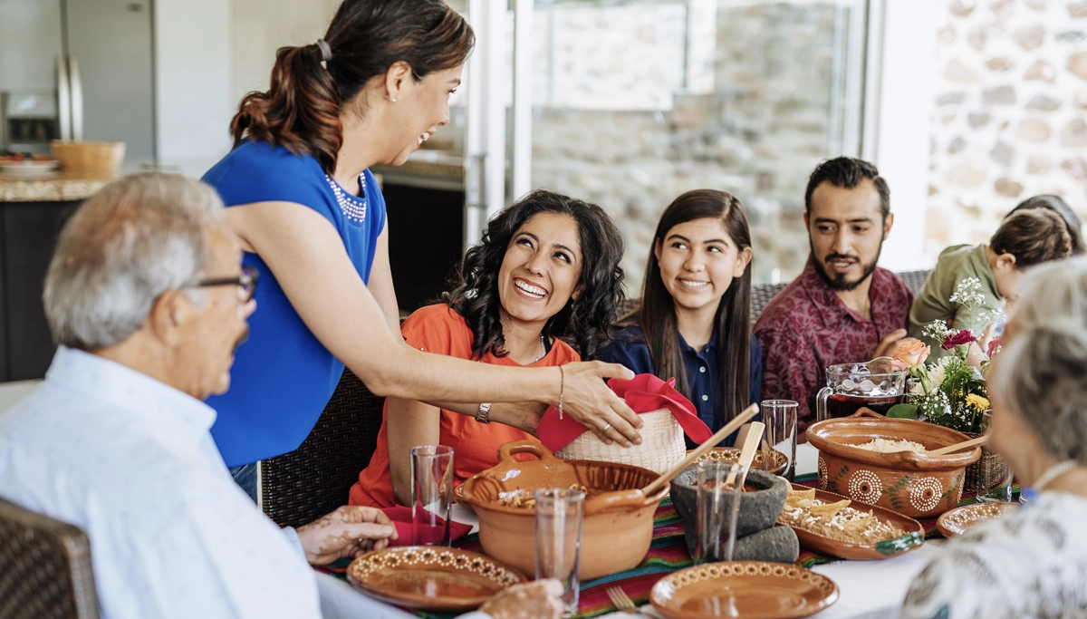 family-smiling-around-thanksgiving-table-1200x683.webp