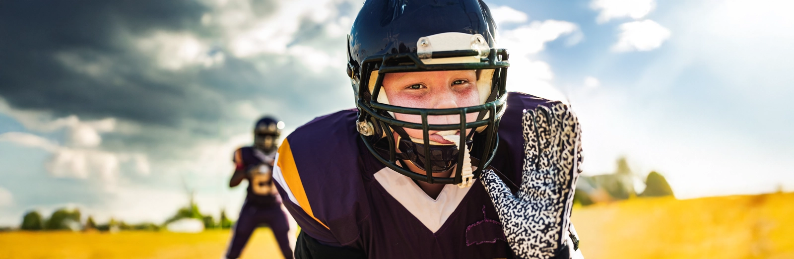 young-boy-playing-football-1600x522.webp