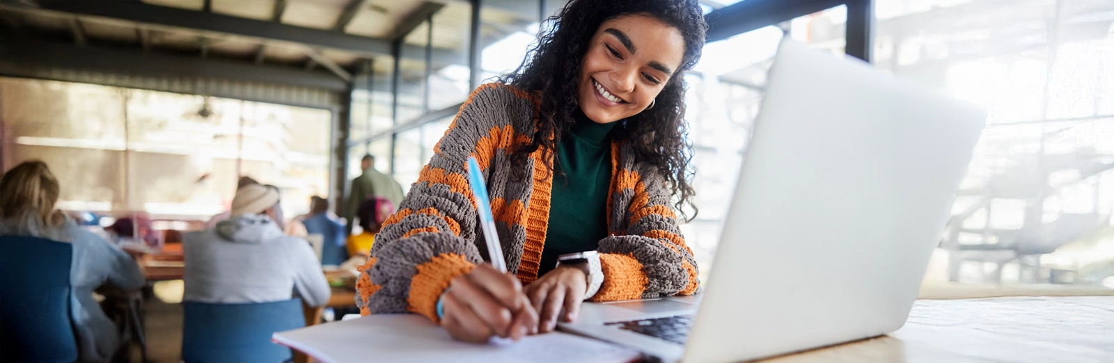 young-girl-smiling-while-writing-1600x522.webp