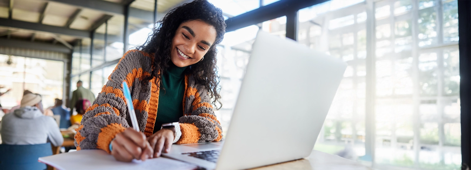young-girl-smiling-while-writing-1600x578.webp