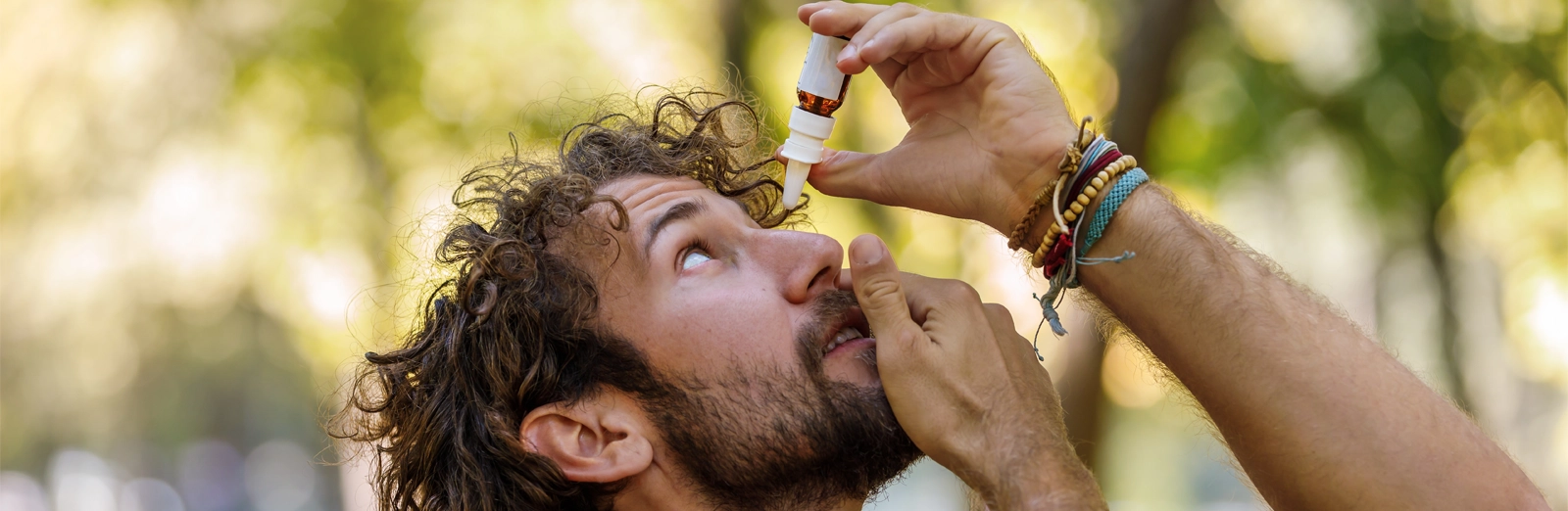 man-putting-eye-drops-in-outside-1600x522.webp