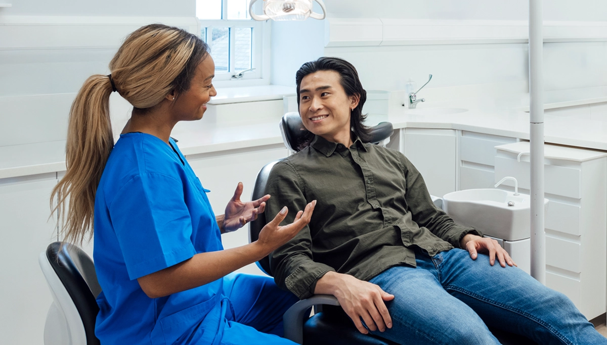 dentist-talking-with-smiling-patient-1200x683 .webp