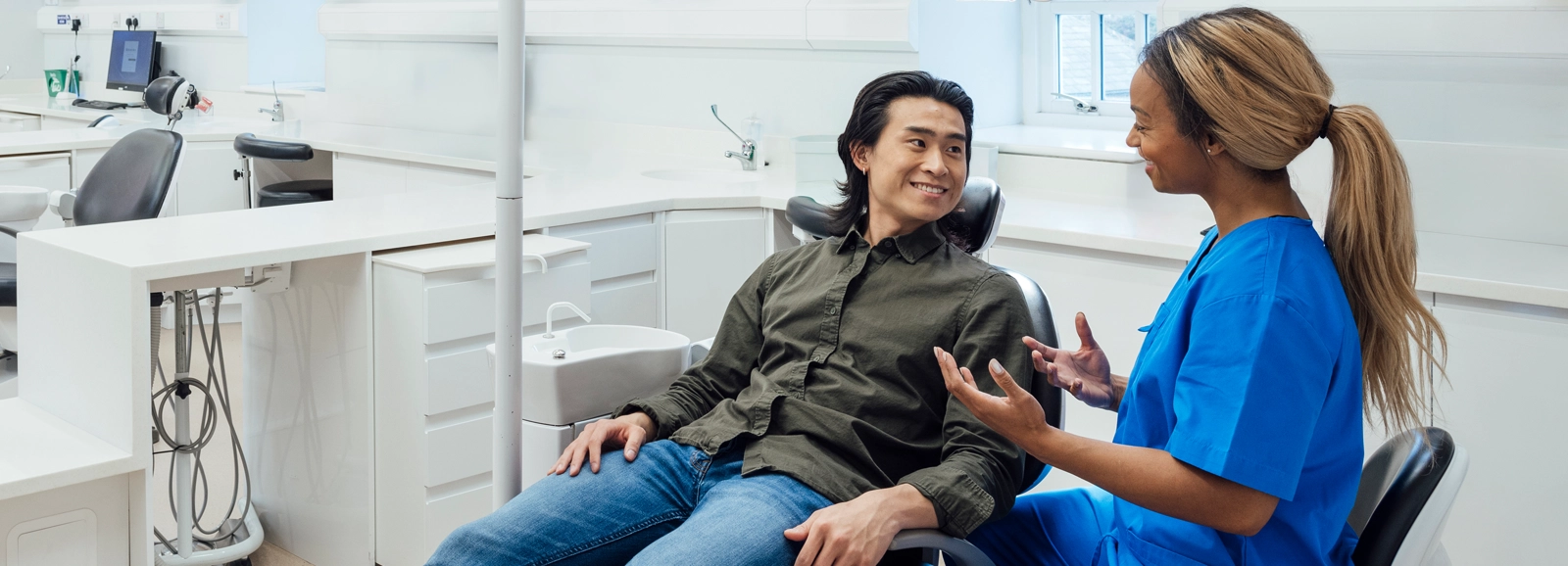 dentist-talking-with-smiling-patient_homepage-1600x578.webp