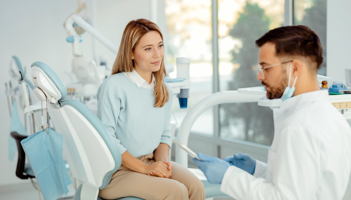 woman-at-dental-office-talking-with-dentist-1200x683.webp