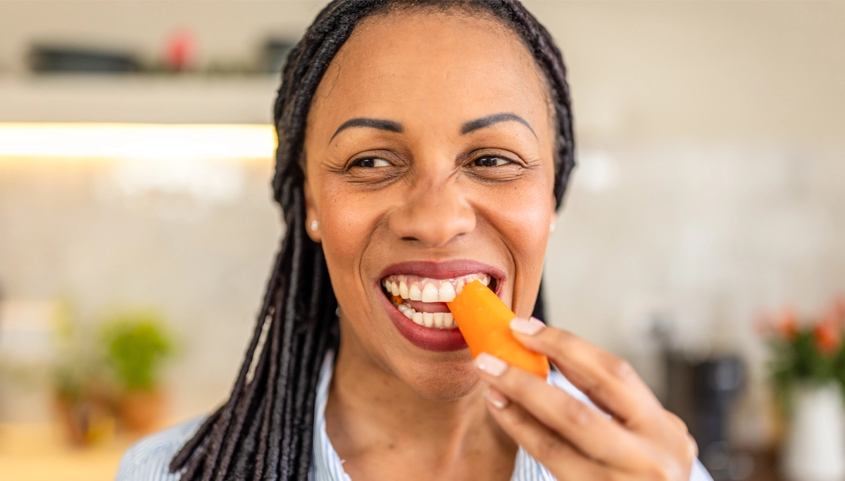 woman-eating-a-carrot-1200x683.webp