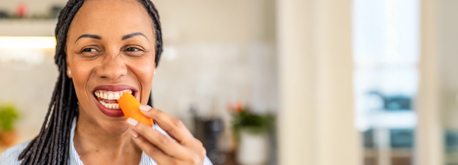 woman-eating-a-carrot_homepage-1600x578.webp