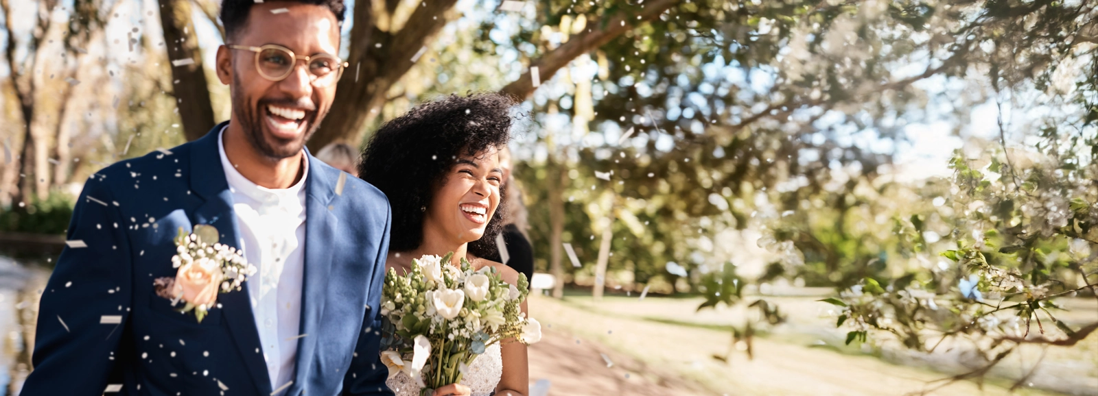 bride-and-groom-smiling-outside-1600x578.webp
