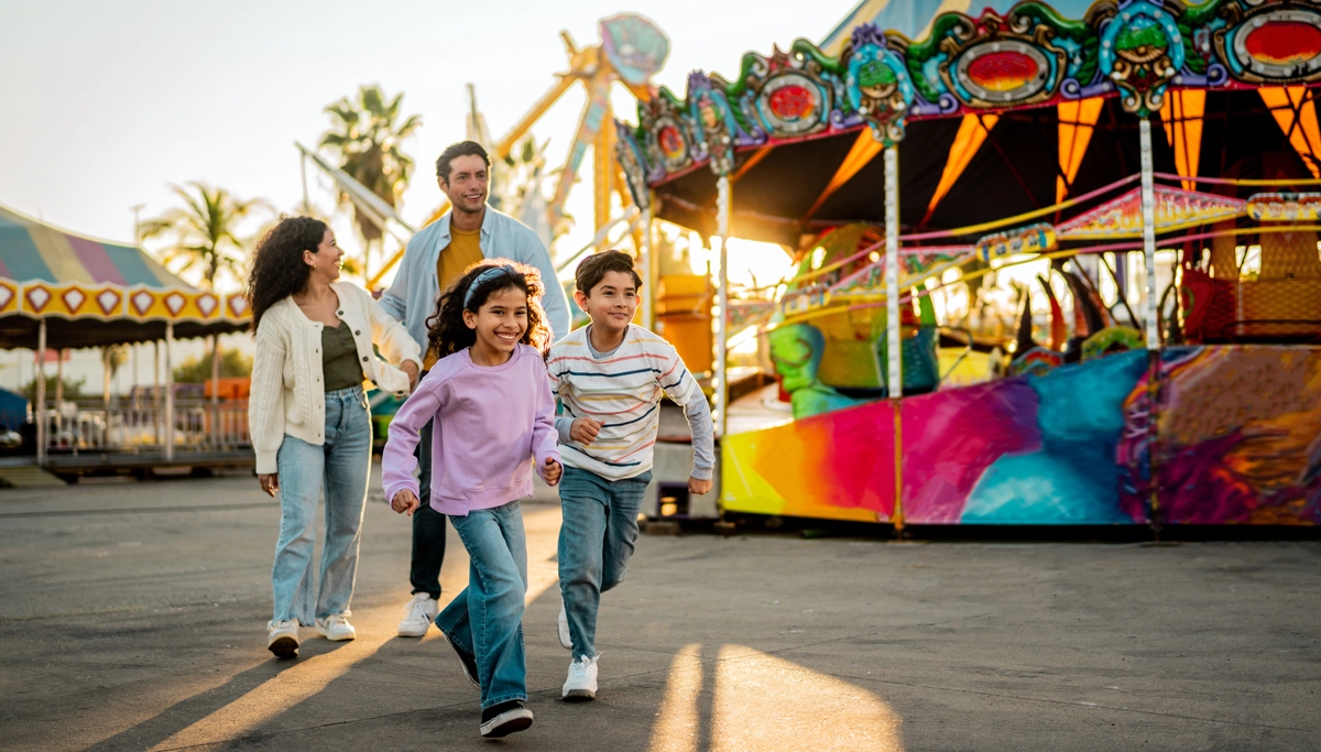 family-laughing-at-the-amusement-park-1200x683.webp