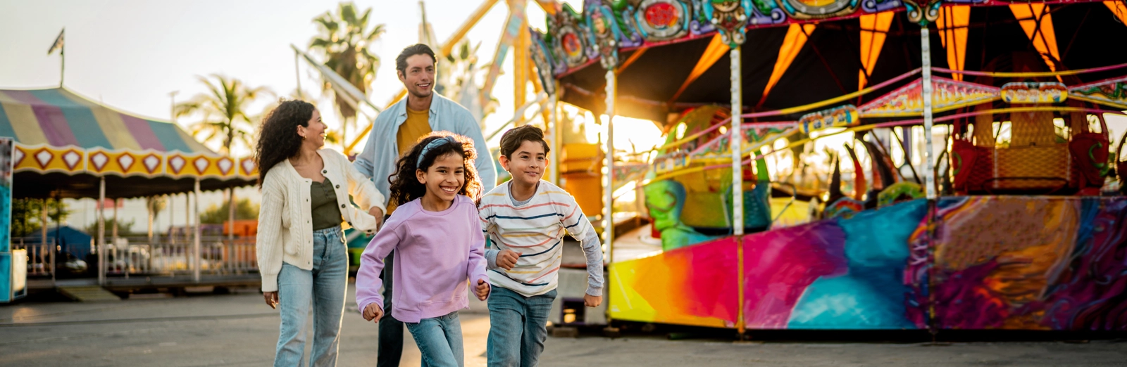 family-laughing-at-the-amusement-park-1600x522.webp