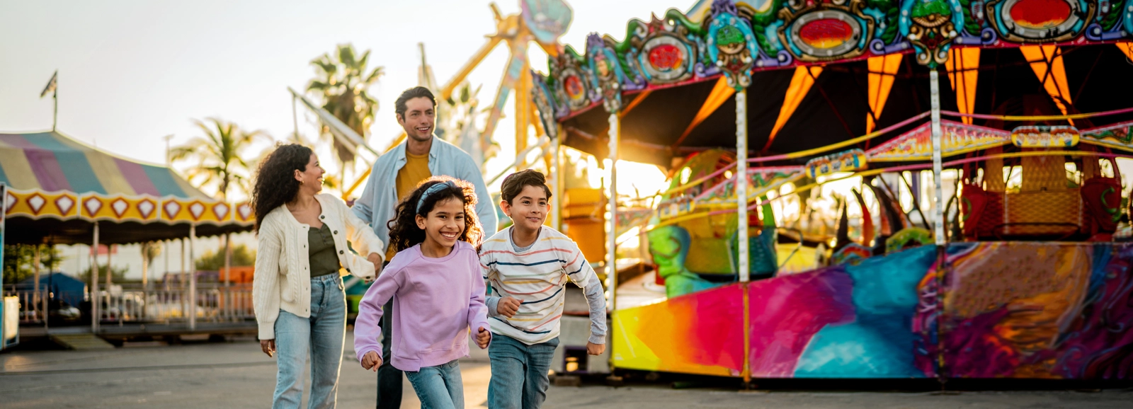 family-laughing-at-the-amusement-park-1600x578.webp