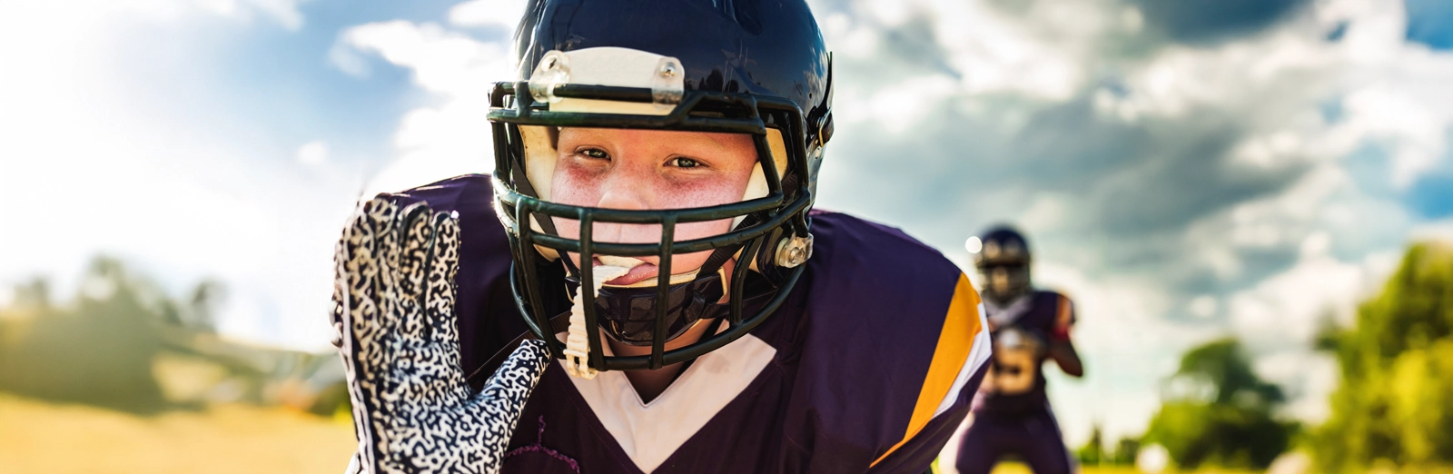 young-boy-playing-football-1600x522.webp