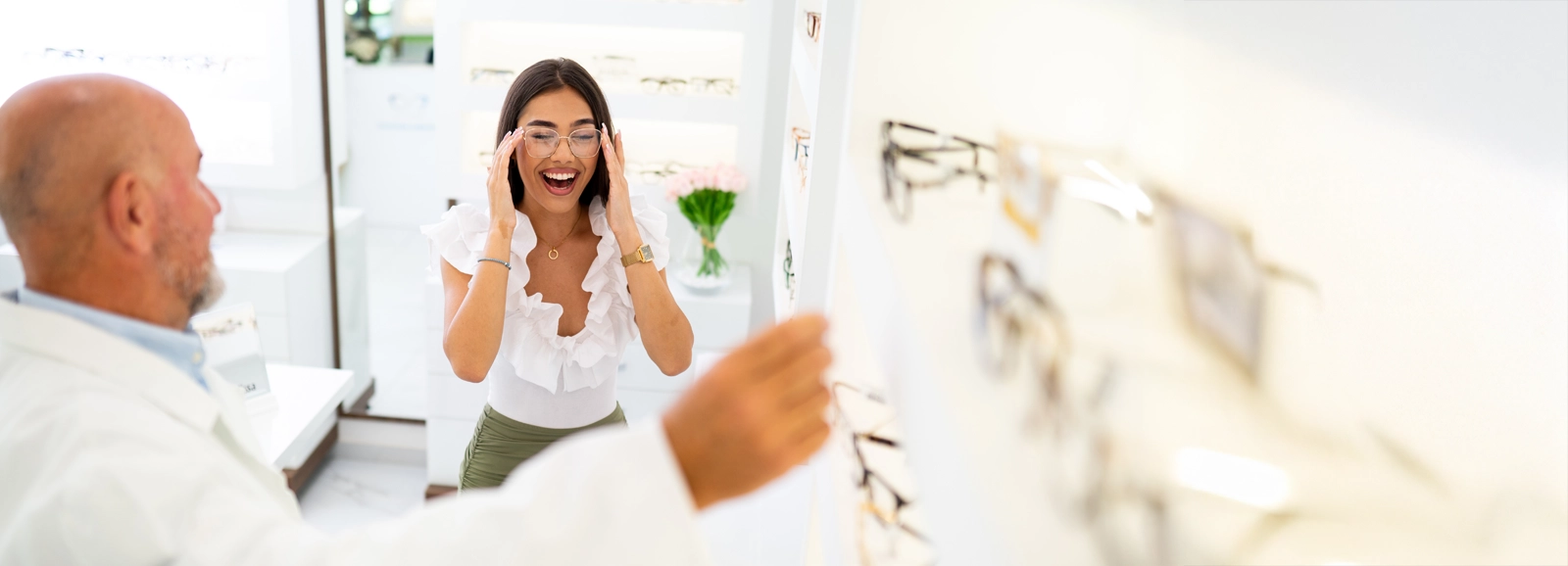 woman-smiling-in-glasses-at-optometrist-1600x578.webp